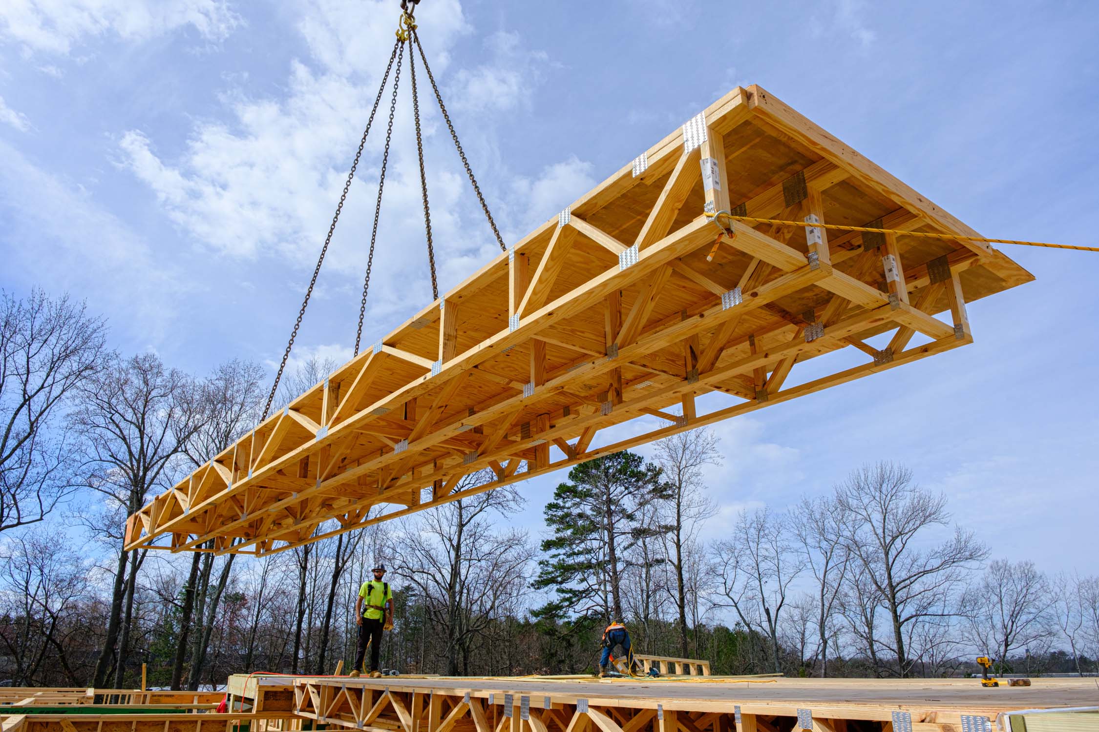 Floor cassettes being lifted by crane at a job site
