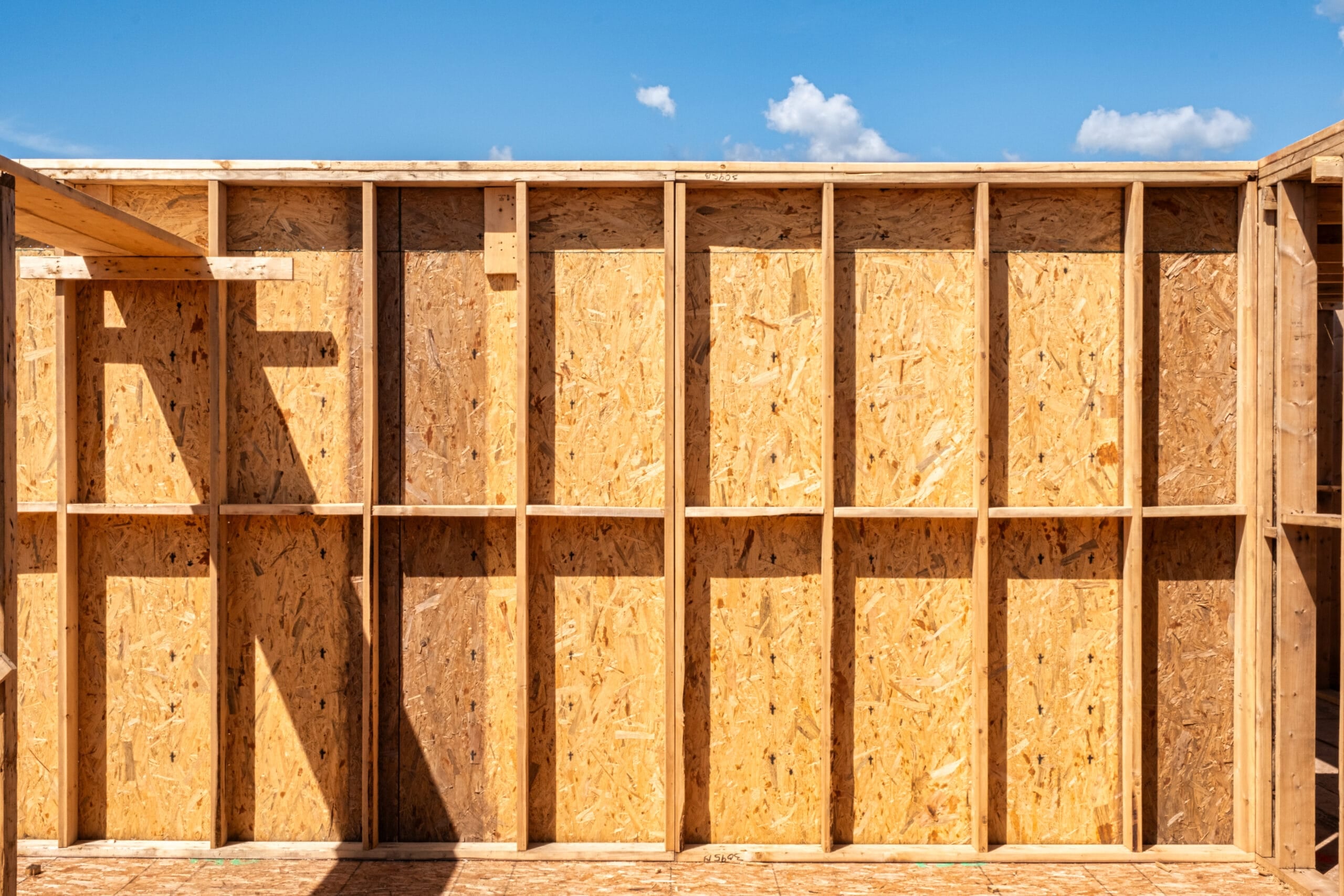 Prefabricated wall panels being set on a job site